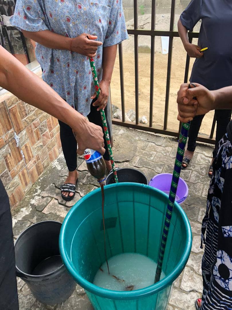 Participants adding ingredients to a soap-making mixture